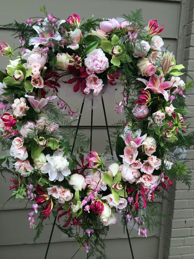 Memorial wreath of pink and white roses, peonies, and garden flowers