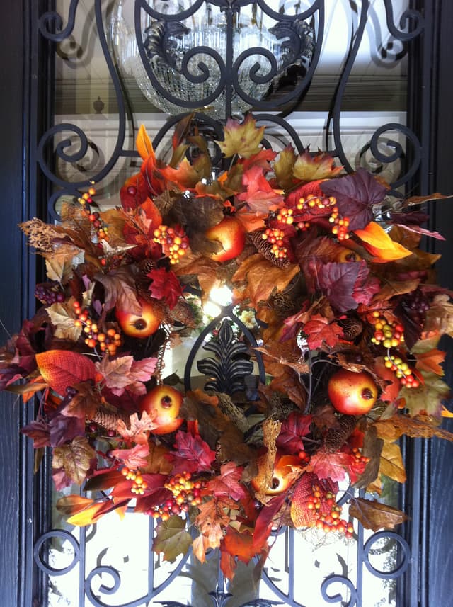 Autumn front-door wreath of fall foliage, pomegranates, and berries