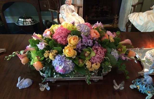 Soft garden-rose arrangement with butterflies for a new baby