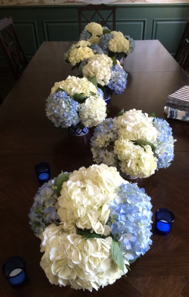 Table runner of mounded blue and white hydrangea