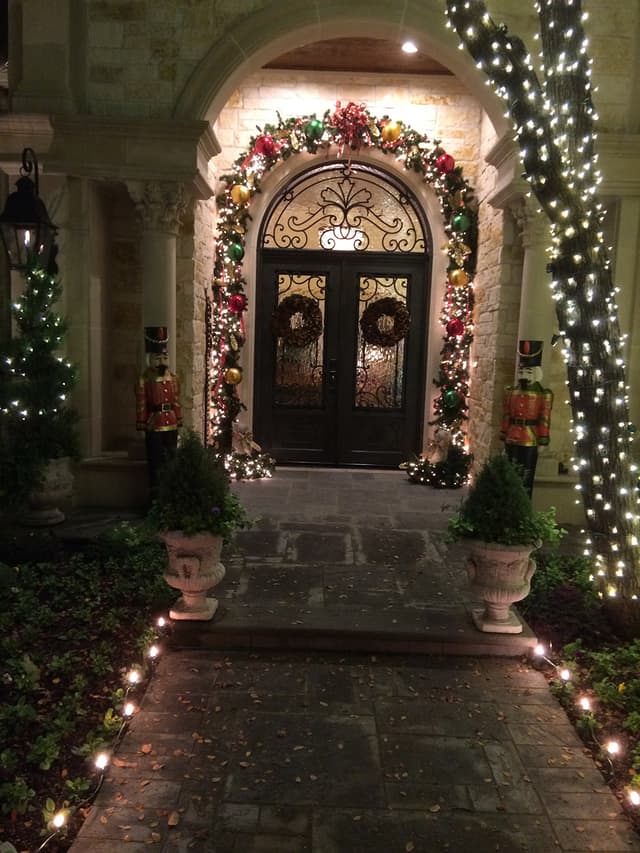 Home entry decorated with holiday garland and wreaths