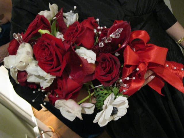 Winter wedding bouquet of red and white roses with crystal accents
