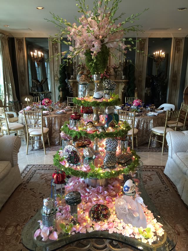 Elegant room display with rose petals and a lighted moss table