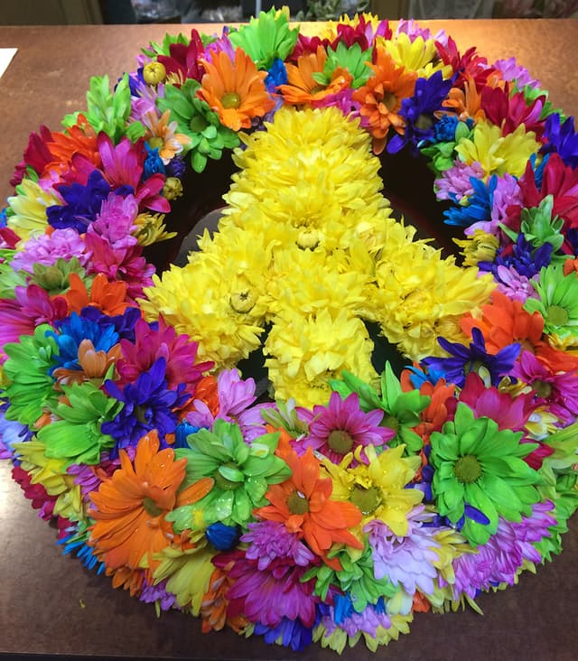 Peace sign wreath of brightly colored daisies