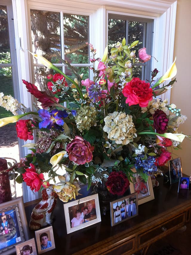 Lush silk English garden arrangement in reds, blues, and purples