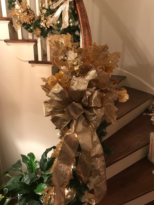 Gold metallic swag and garland styled down a staircase