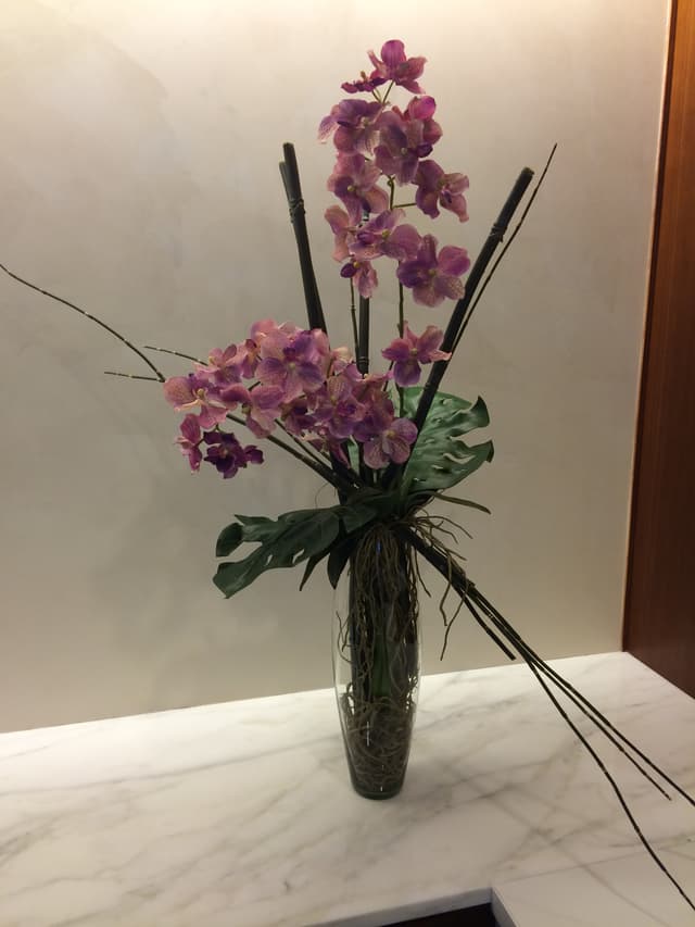 High-style silk design of orchids and split-leaf philodendron