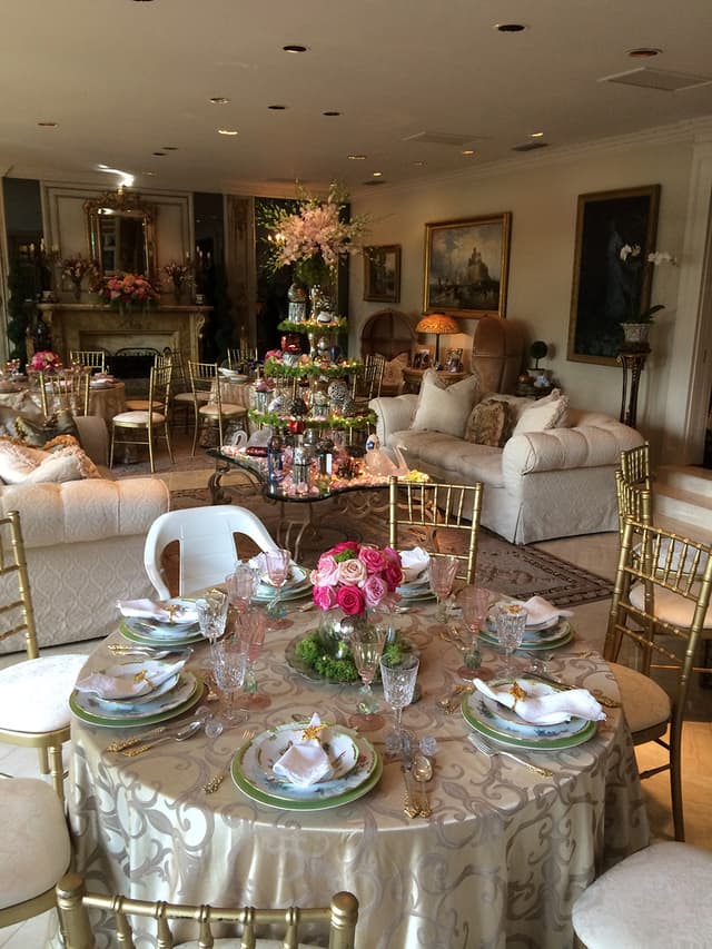 Luncheon table with a low pink and gold floral centerpiece