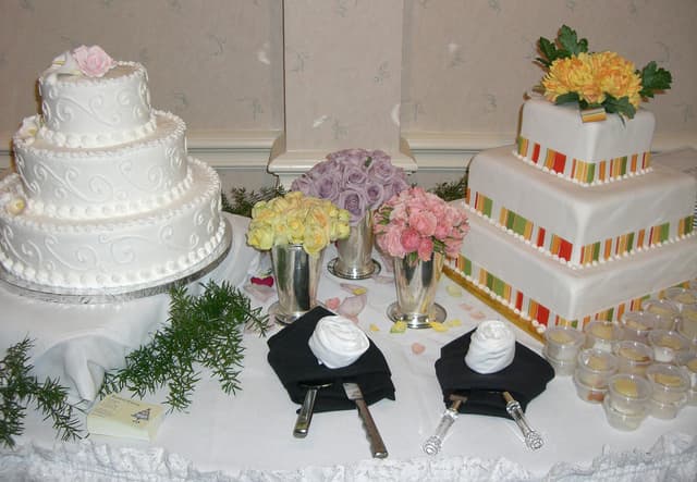 Wedding cake and reception table decorated with fresh flowers